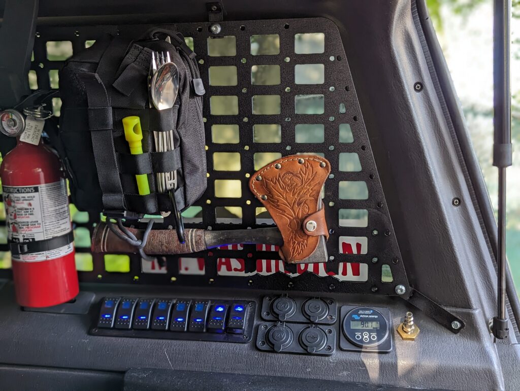 Trail & Co. Jeep XJ Trunk Window Molle Panel with tools and accessories attached.